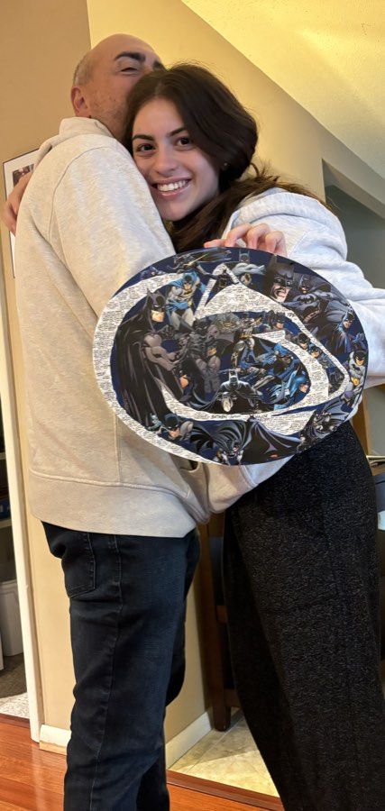 One daughter holding a finished Batman collage